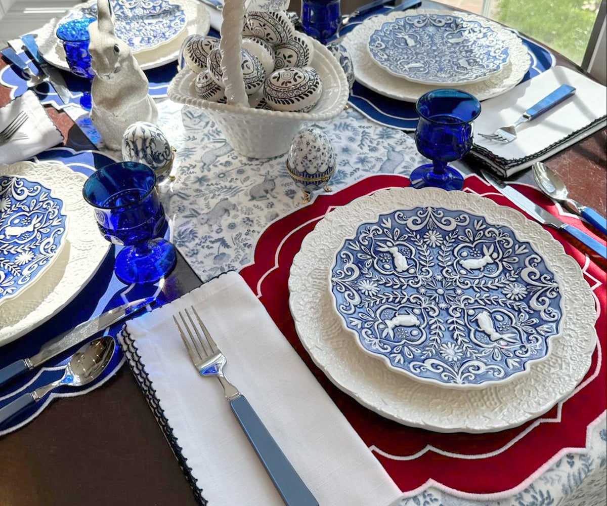 "Elegant dining table setting featuring assorted placemats in different textures and patterns, with complementary tableware, cutlery, and fresh flowers, enhancing the dining experience."