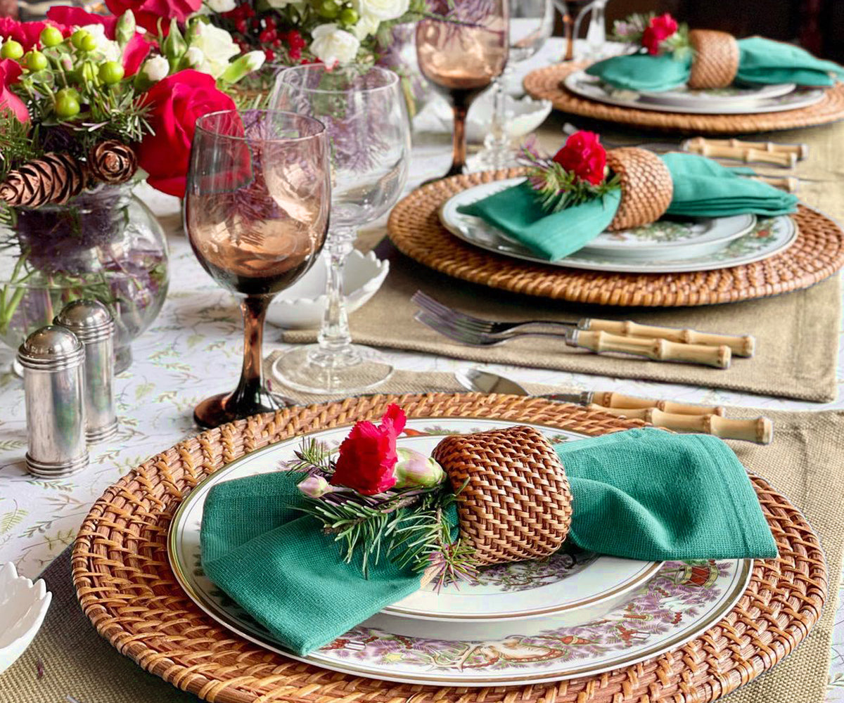 Rustic dining table set with beige placemats and matching napkins.