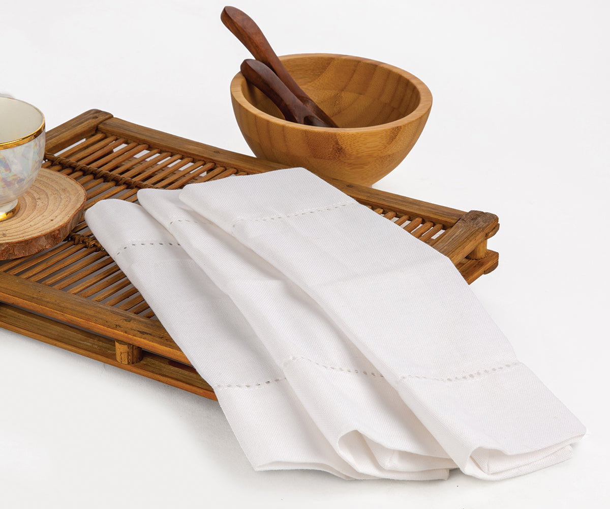 Elegant cotton and linen cocktail napkins in classic white, perfect for parties and events.