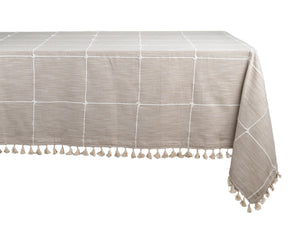 Checked tablecloth with tassel accents, perfect for creating a charming dining table setup.