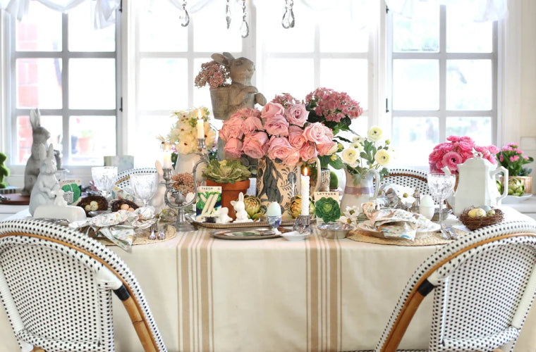 Farmhouse tablecloth with floral centerpieces and spring decor.