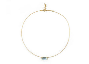 A 18k gold necklace with a blue pendant.