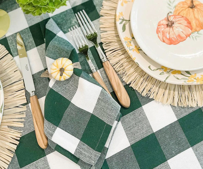 Colorful plaid napkins neatly folded on a dining table