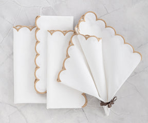 "Elegant white napkin with scalloped edges, neatly folded."
