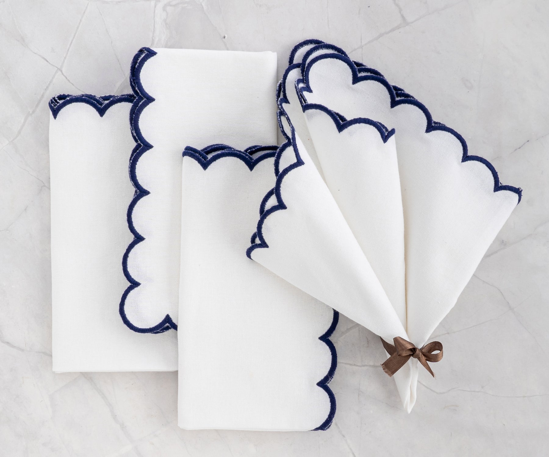 Overhead view of scalloped napkins folded into a triangle