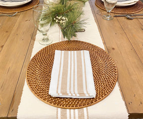 Beige and white striped cotton napkins set of 6 on a rustic dining table.