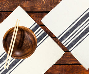 Grain Sack Stripe Placemats on a wooden table, set with a breakfast spread