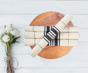 Four rolled Navy Blue Country Striped Placemats, tied with string. 