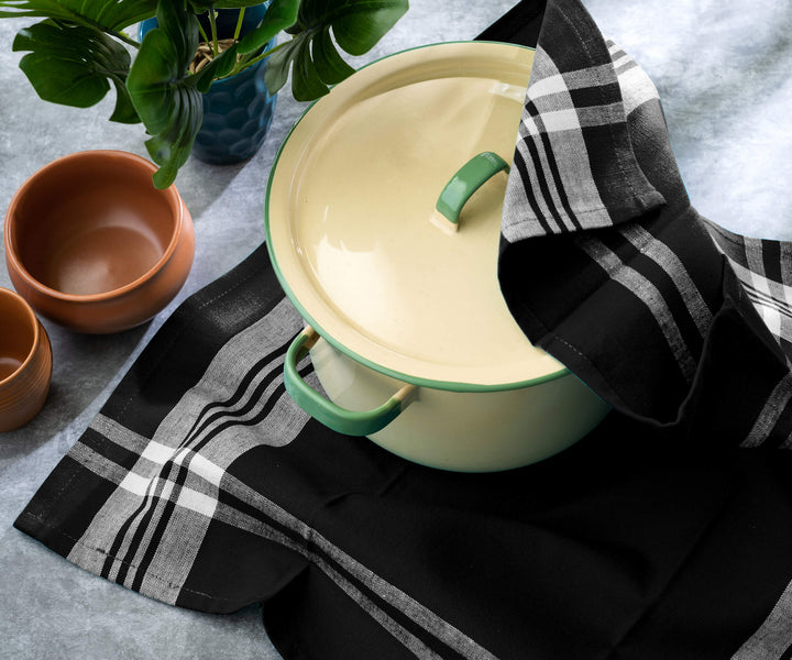 Striped kitchen towels with alternating colorful stripes hanging on a rack or draped over a counter.