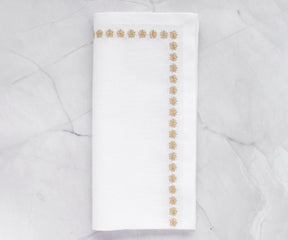 Rich gold-colored napkins, enhancing the elegance of any dining arrangement with their soft texture.