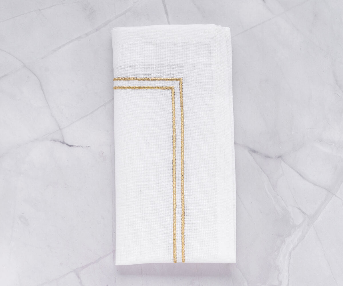 Classic white napkin with a delicate gold border trim