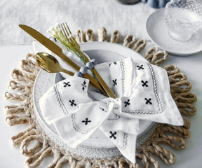 Set of embroidered white cotton napkins for dining table