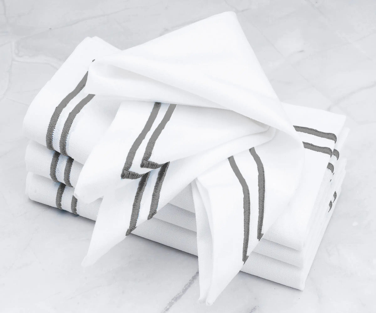 Premium linen napkins accented with a double line of gray embroidery.