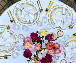 Dining table adorned with round gold placemats, featuring a luxurious and stylish look perfect for special occasions.