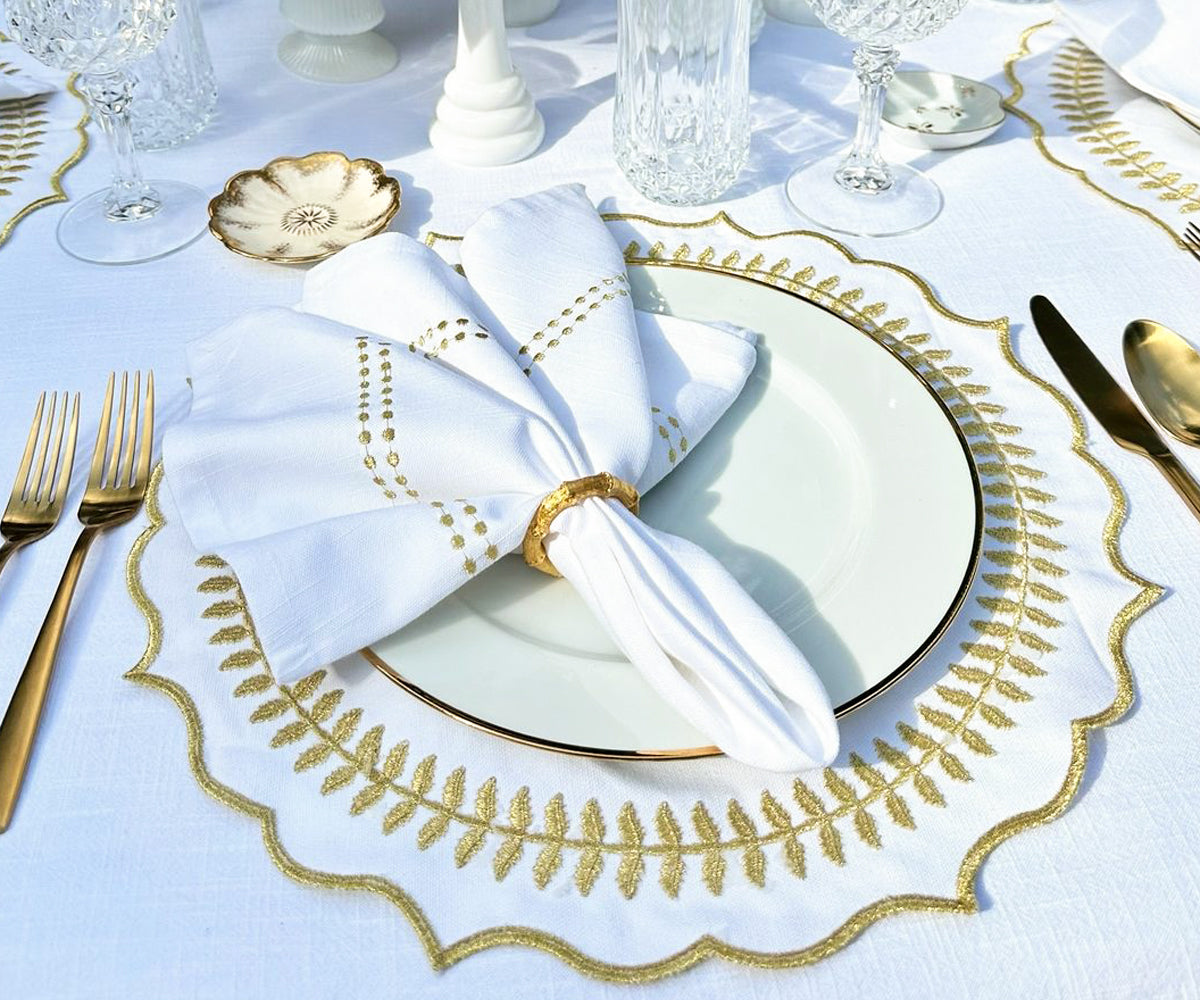 Set of four round gold placemats, displaying a radiant and classy appearance, ideal for enhancing any dining experience..