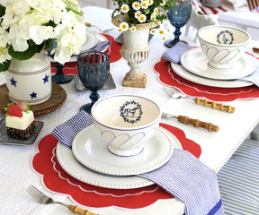 Bright red round placemats placed on a wooden table, adding a pop of color to the dining setup.