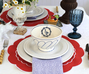 Elegant red round placemats displayed on a glass table, enhancing the table decor with a bold touch..