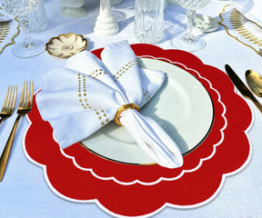 Red round placemats, perfectly aligned on a table, providing a modern and chic look for dining.