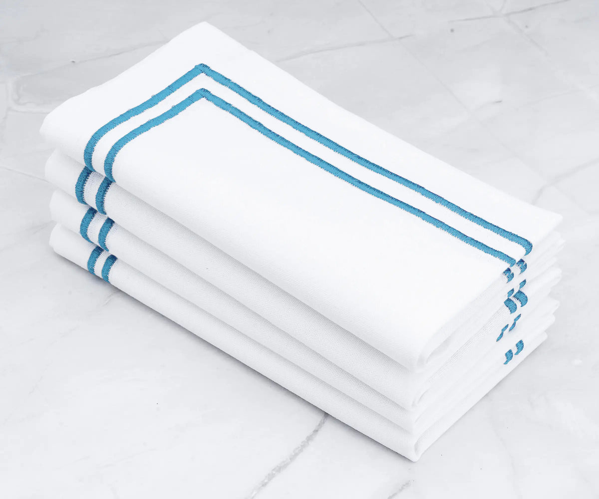 A touch of serenity White napkins with light blue embroidered lines