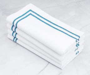 A touch of serenity White napkins with light blue embroidered lines