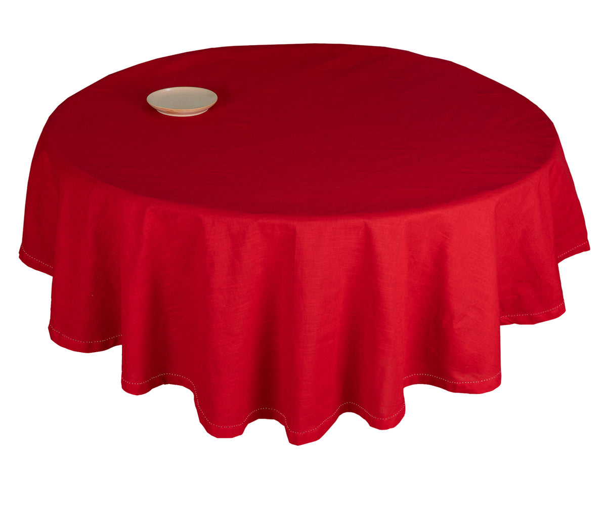 A red round tablecloth for a dining table.