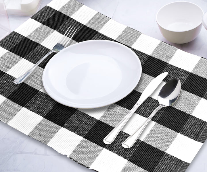 Black and white Plaid placemats featuring a checkered pattern, set on a dining table.