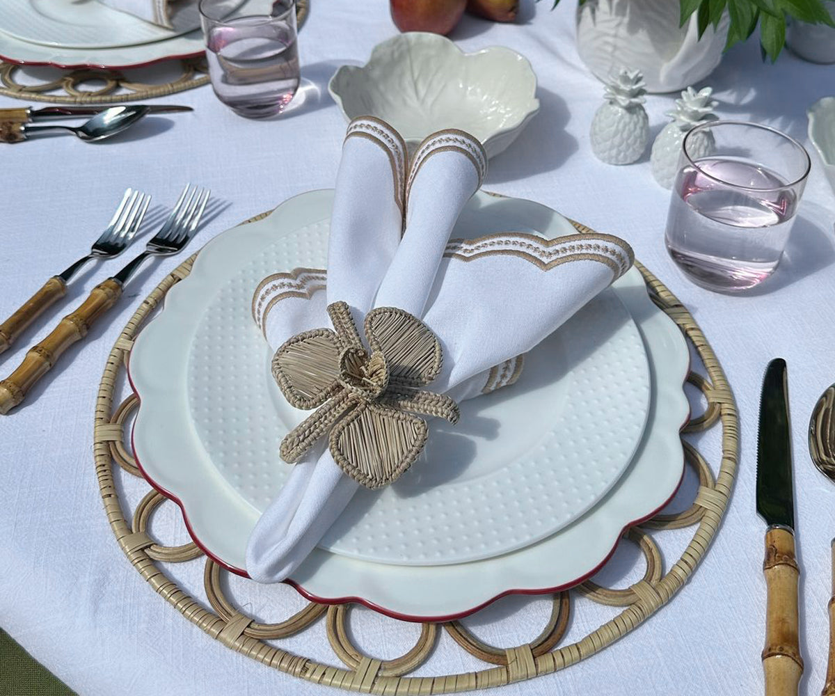 Beige scallop napkins neatly arranged on a rustic wooden table, providing an elegant and sophisticated touch to the table setting.