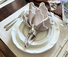 Beige scallop napkins providing a refined touch to a holiday dinner table