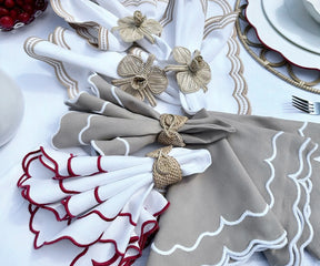 Close-up of beige scallop napkins folded elegantly, perfect for a refined dining experience.