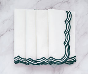 High-quality white napkins with deep green scalloped trim, designed for elegant table settings.