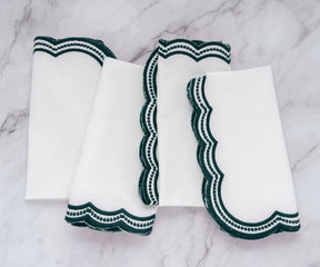 Stylish green embroidered napkins with a scalloped design, perfect for weddings and special occasions.