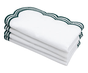 Luxury green scalloped embroidered napkins on a marble surface, perfect for fine dining.