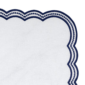 High-quality embroidered napkins featuring navy blue scalloped edges, adding sophistication to any table setting.