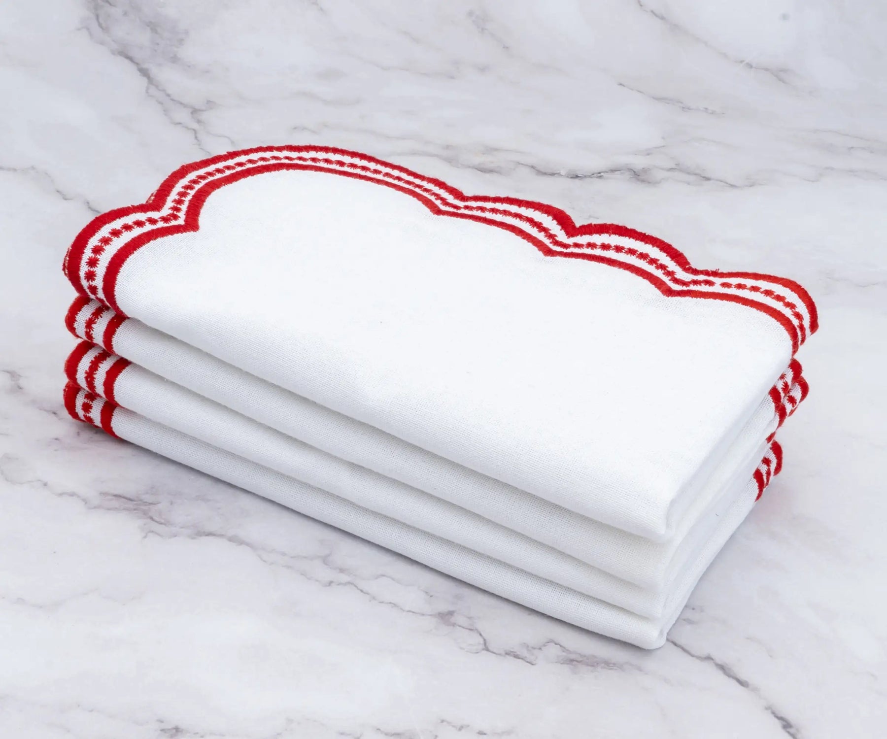 High-quality white napkins with bold red scalloped trim, designed for refined dining experiences.