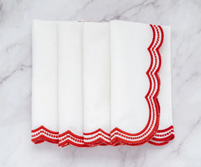 Soft cotton napkins with delicate red embroidered scalloped details, perfect for classic and modern table setups.