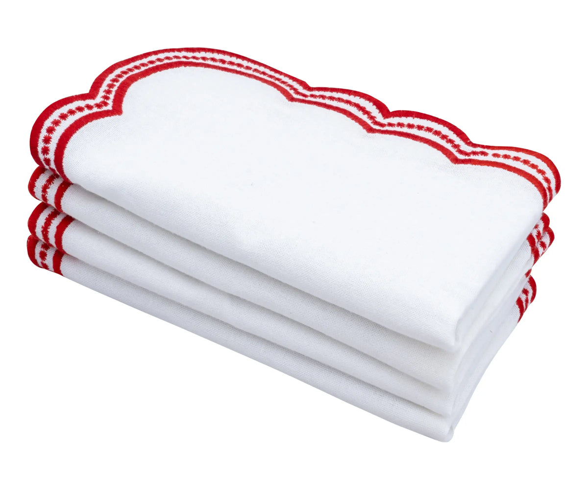 Set of white linen napkins with intricate red scalloped embroidery, adding sophistication to any meal.