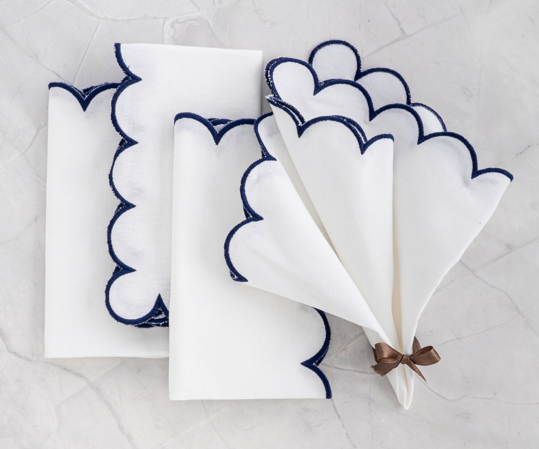 Scallop napkins - cloth napkins with scalloped edges, accented by embroidered details."