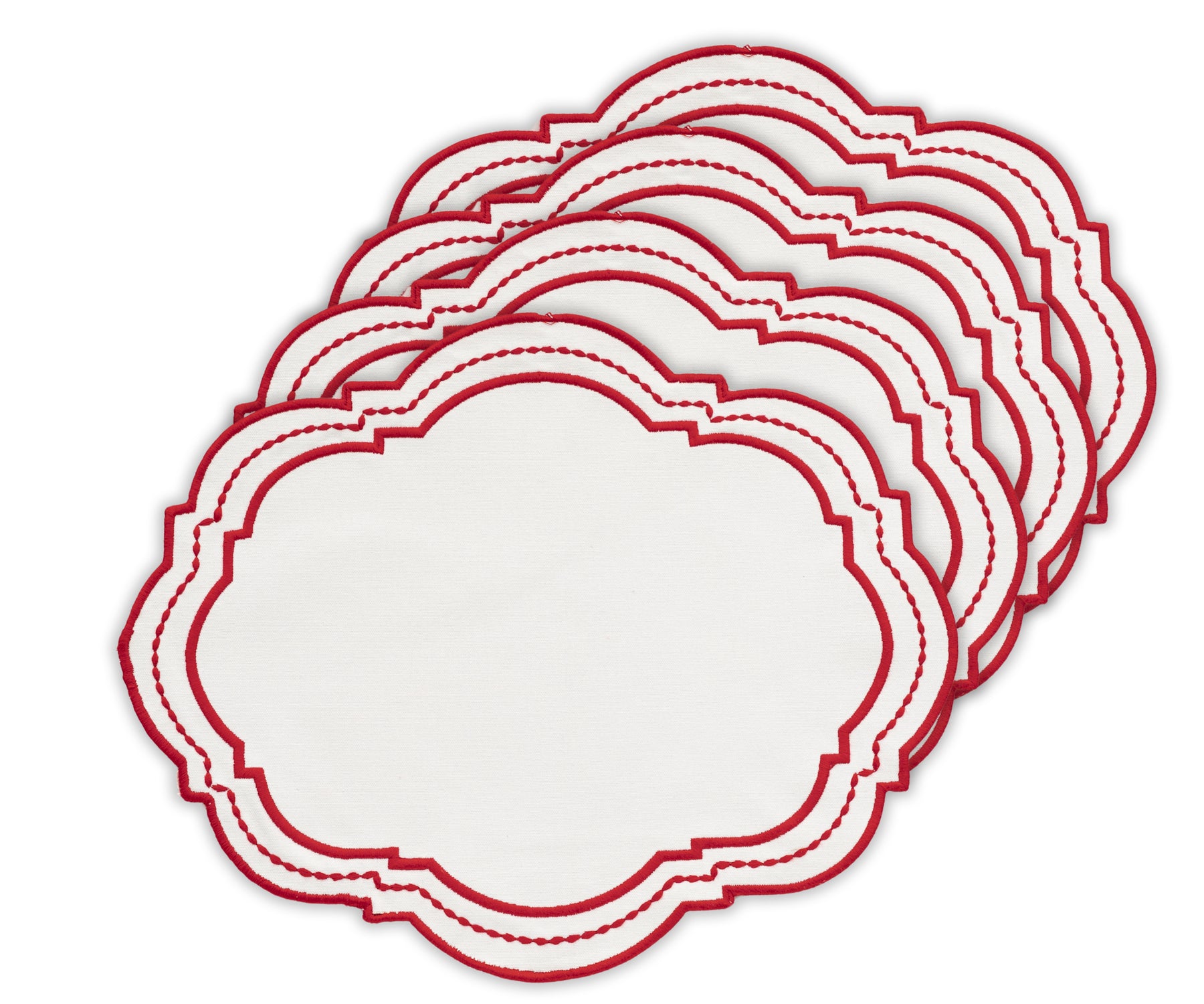 Red oval placemat with contrasting white dot accents, styled with matching cutlery.
