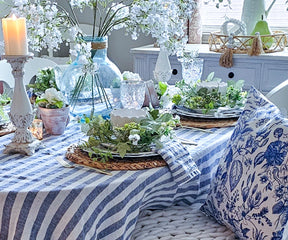 A set of blue linen napkins draped over a rustic wooden table, highlighting their casual yet sophisticated appeal.