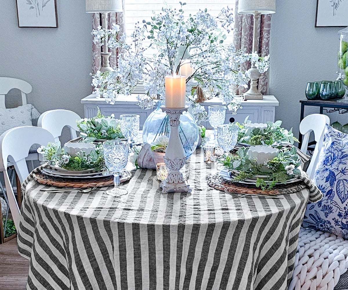 Folded linen napkins in soft, black colors, neatly arranged on a dining table, showcasing their smooth texture and elegant design.