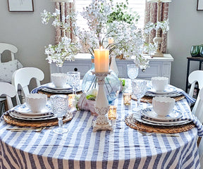 Elegant linen napkins folded into intricate designs, placed next to fine cutlery on a formal dining table setting.