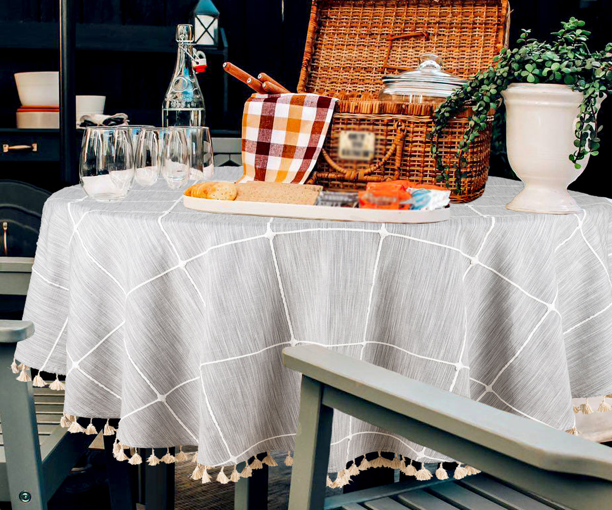 A round tablecloth with an intricate paisley design in warm earthy tones.