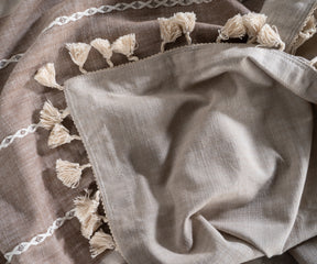 tassel-striped linen tablecloth, perfect for covering rectangular tables and enhancing dining experiences.