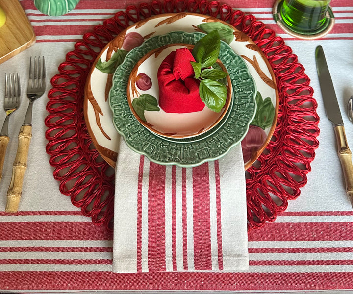 Red and white striped napkins folded on a dining table.