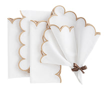 Decorative napkin with scalloped edges styled for a formal dinner.