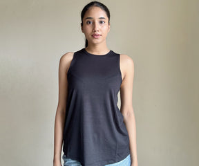 Image of a variety of women's tank tops in different styles and colors, including white, black tank tops. 