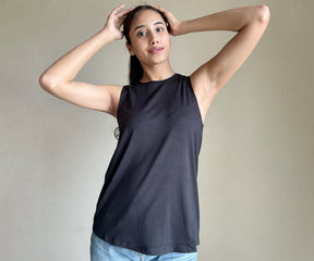 Close-up of women's tank tops in a range of styles and designs, showcasing white, black, and colorful options. 
