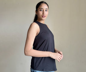 Close-up image of women's tank tops displayed in different designs, highlighting essential wardrobe staples like white tank tops and black tank tops.