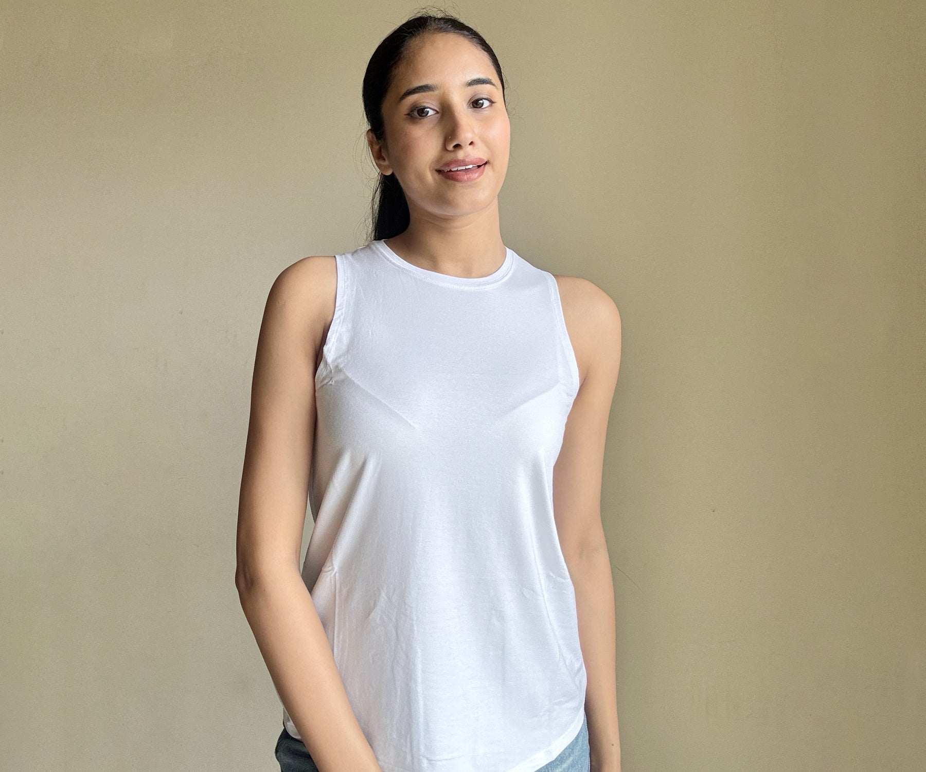 Front view of a model wearing a white tank top and another in a black tank top, highlighting basic yet essential women's tank top styles.
