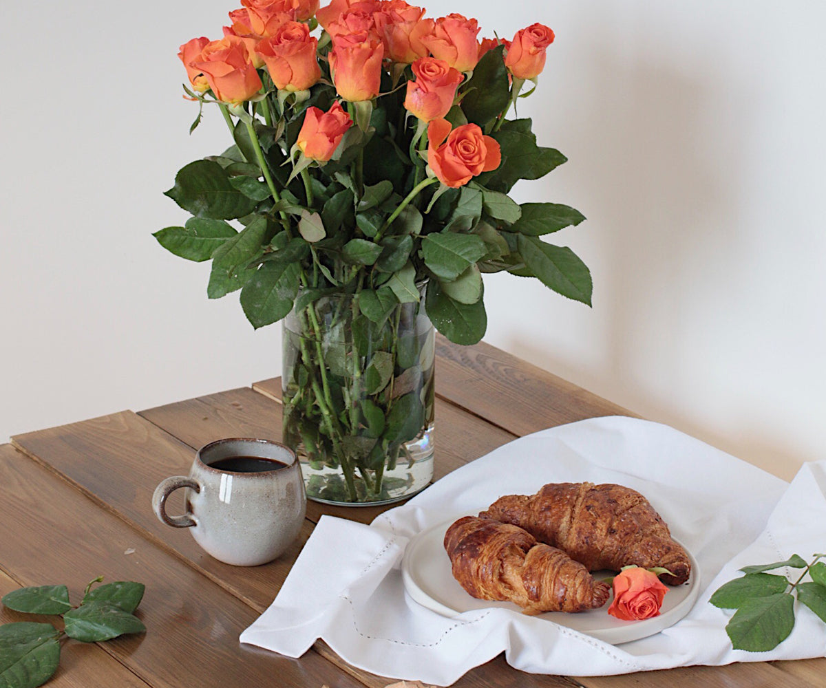 White fabric napkins with decorative hemstitch stitching.